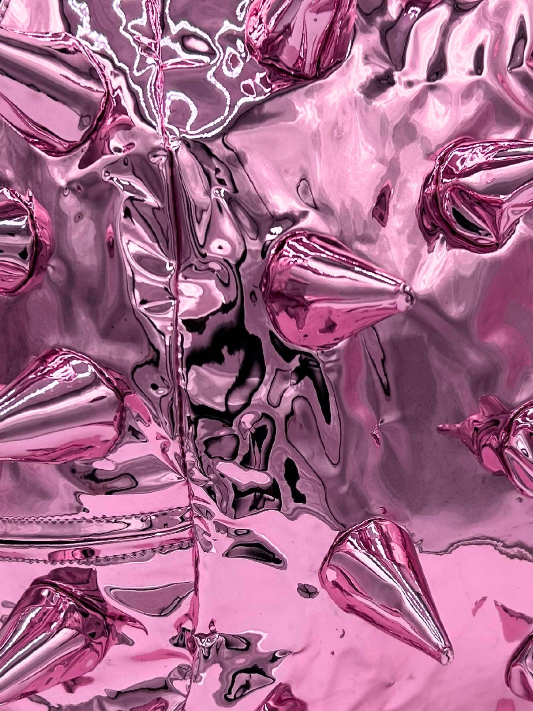 Close up view of metallic pink bookbag with spikes by Madpax